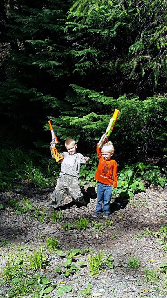Kids with nerf guns in the forest