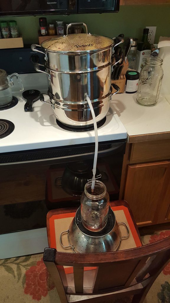 steam juicer set up on a stove