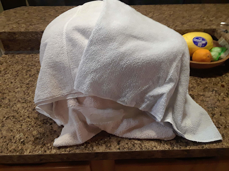 After adding the yogurt culture the crockpot is covered with towels to keep the heat in.