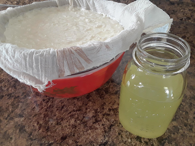 Draining yogurt with a jar of whey