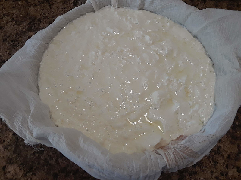 Draining the yogurt to remove the whey