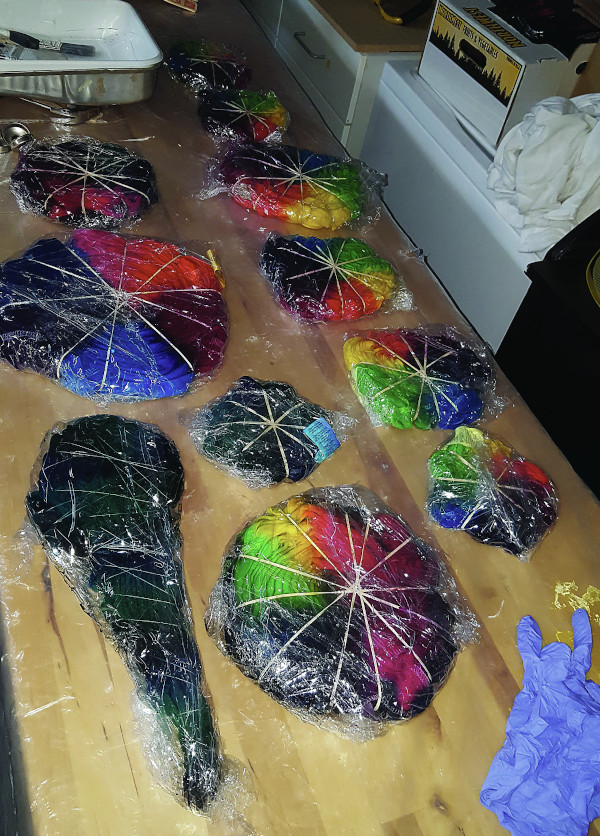tie dye shirts wrapped in saran wrap.